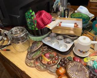 Cast iron trivits, cast iron clcok, muffin pans, glass pot,  Vintage Tupperware, cookie press