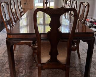 Drexel Heritage "Connoisseur Dining Table. Pictured with Set of 10 Drexel Heritage Fiddleback Dining Chairs. Table Measures 76" L x 40" D with 3 15.5" Leaves; 29" H with 26" Clearance. Photo 1 of 9. 