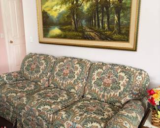 Floral upholstered couch, artwork 