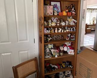 Raton cane chair, tchotchkes, bookshelf.