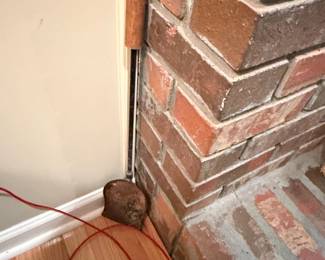 Brick Fireplace Corner with Wooden Tool