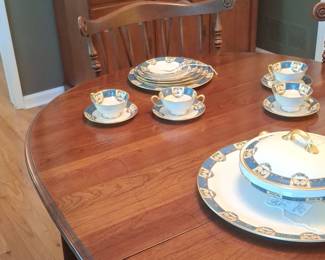 Porcelain Teacup and Saucer Set with Blue and Gold Trim second image