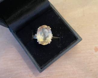 Oval citrin cocktail ring set in 14k gold with two small diamonds