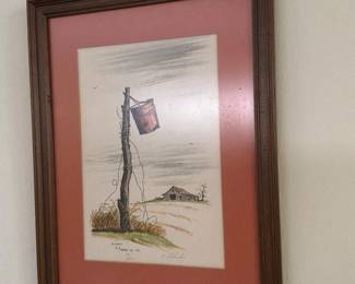 A vintage framed  watercolor  painting depicting  a rustic fence post and a hanging bucket signed a number