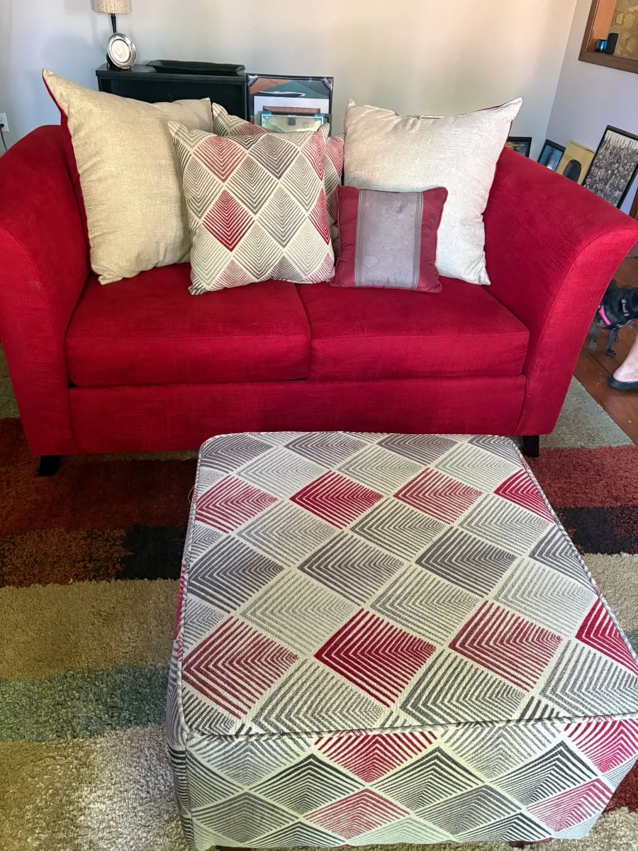 Red love seat, pillows, ottoman