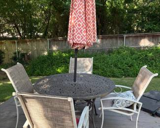 patio table with chairs and umbrella