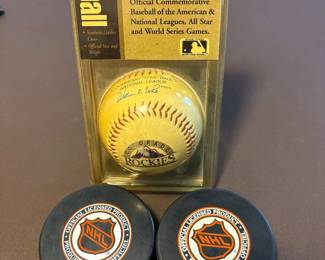 c Colorado Rockies Commemorative Baseball with Two NHL Hockey Pucks
