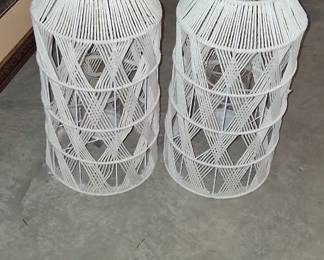 Hanging lanterns of white woven lanterns featuring a rope handle and diamond pattern