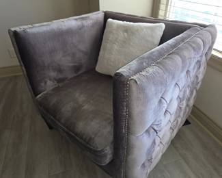 Gray tufted armchair