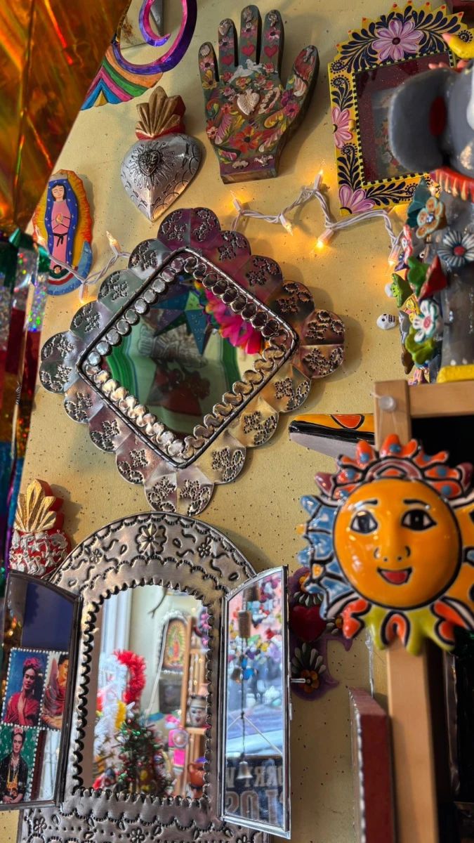 Talavera pottery sun, tin mirror and other folk art.