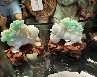 Small pair of well carved Chinese Jadeite foo lions on carved stands