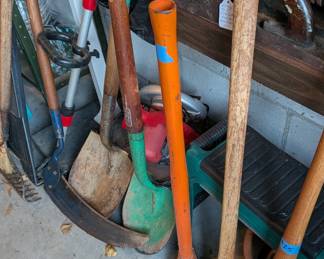 Vintage tools: straight handle hay scythe, wood handle shovels, double sided ax with vintage wear to wood, nice old Roger Maris model wood baseball bat.