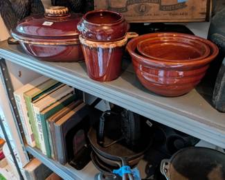 Cast iron eagles, corn stick baker, many iron skillets, antique meat grinder in old wood box.