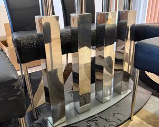 Beautiful glass dining room table with unique glass base.   Six chairs need to be  upholstered.   Table  71 in L x 40 in W x 29.5 in H Chairs 18in L x 18.5 in W x 40 in H