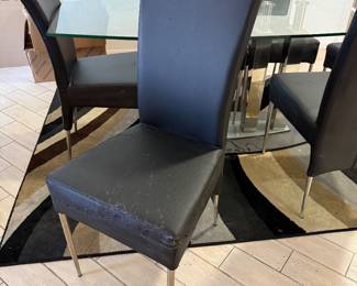 Beautiful glass dining room table with unique glass base.   Six chairs need to be  upholstered.   Table  71 in L x 40 in W x 29.5 in H Chairs 18in L x 18.5 in W x 40 in H