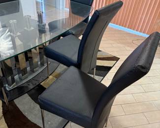 Beautiful glass dining room table with unique glass base.   Six chairs need to be  upholstered.   Table  71 in L x 40 in W x 29.5 in H Chairs 18in L x 18.5 in W x 40 in H