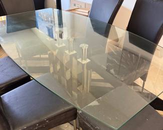 Beautiful glass dining room table with unique glass base.   Six chairs need to be  upholstered.   Table  71 in L x 40 in W x 29.5 in H Chairs 18in L x 18.5 in W x 40 in H
