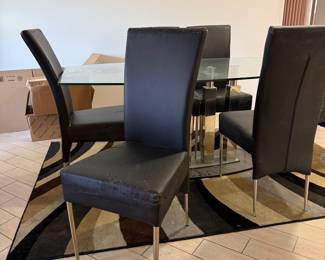 Beautiful glass dining room table with unique glass base.   Six chairs need to be  upholstered.   Table  71 in L x 40 in W x 29.5 in H Chairs 18in L x 18.5 in W x 40 in H