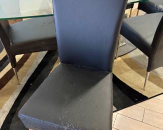 Beautiful glass dining room table with unique glass base.   Six chairs need to be  upholstered.   Table  71 in L x 40 in W x 29.5 in H Chairs 18in L x 18.5 in W x 40 in H