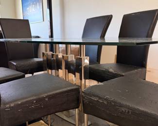 Beautiful glass dining room table with unique glass base.   Six chairs need to be  upholstered.   Table  71 in L x 40 in W x 29.5 in H Chairs 18in L x 18.5 in W x 40 in H