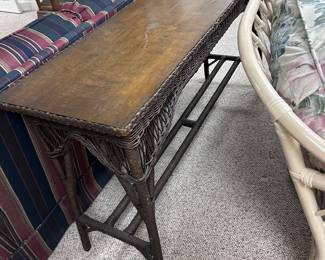 Behind the couch rattan tall table