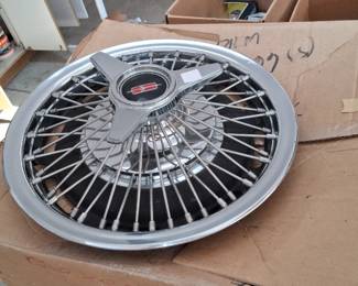 vintage  set of 1964-1966 Oldsmobile wire wheel covers featuring a 3-bar spinner.