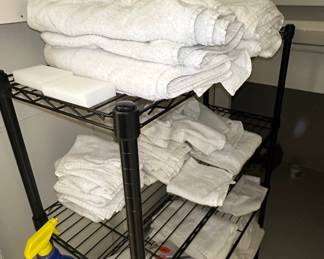 Wire Shelving Unit with Towels and Cleaning Supplies