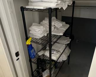 Wire Shelving Unit with Towels and Cleaning Supplies