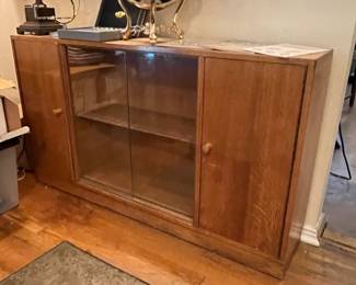 Nice mid-century modern cabinet with visible sliding glass center doors and close cabinets on the wings