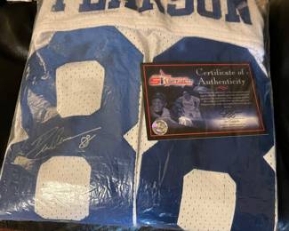 Lots of Signs sports memorabilia here… Including helmets basketballs this jersey several pictures and some really cool sports cards as well