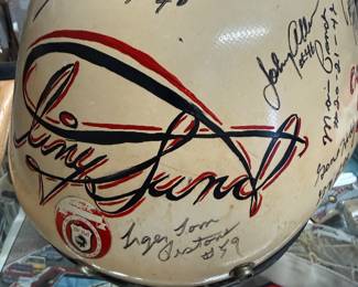 Tiny Lund helmet with tons of autographs