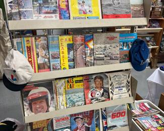 Rack full of tons of old race programs from different tracks. This is 3 deep with programs.