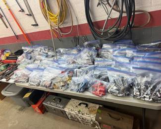 Table full of bags of name brands sockets, wrenches, etc.