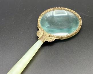 antique magnifying glass featuring a pale green jade handle