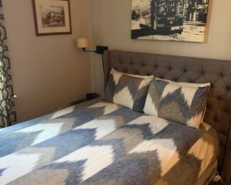 Grey tuffeted queen headboard and frame with queen mattress and box springs