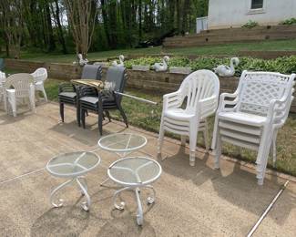 White Stackable Plastic Patio Chairs and White Metal-Framed Glass-Top Side Tables