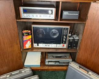 Vintage Electronics Collection with Panasonic Reel-to-Reel, Sansui Receiver, and Polaroid Camera in Wooden Cabinet
