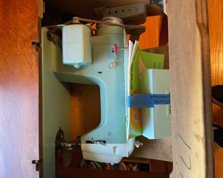 	#33		New Home sewing machine in table with attachments and manual (untested, 22–44 x 17.5 x 31)	 $ 75.00 																							