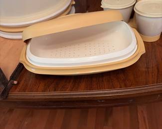 	#66		4 piece Tupperware lot including condiment/candy set, vegetable steamer, tall cake carrier with handle and extra plates, and lunch box set	 $ 25.00 																							