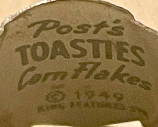 **RARE   MID-CENTURY 1949 POST'S TOASTIES CORN FLAKES TIN GUMBALL MACHINE RING - MAMA BUMSTED