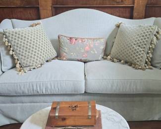 Light Blue Upholstered Camelback Sofa with Decorative Pillows