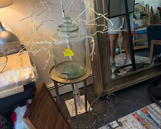 Glass water jug dispenser on metal stand