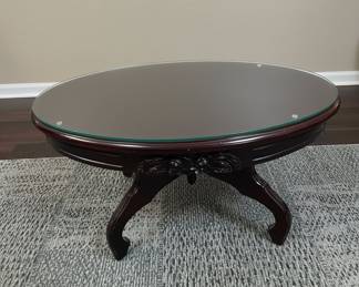 Dark Wood Oval Coffee Table with Carved Detailing and Glass Top