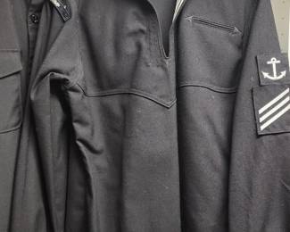 WWII-era U.S. Navy wool jumper with a navy blue color, white braid trim, and a single anchor insignia
