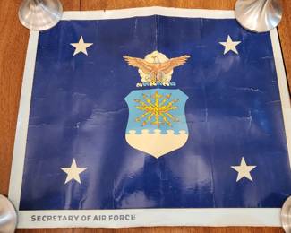 Poster of the United States Air Force flag featuring the service's emblem, a bald eagle above a shield with a sunburst, set against a blue background with four white stars