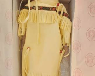 Georgetown Collection porcelain doll dressed in a yellow fringed outfit