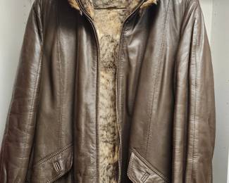 Brown leather bomber-style jacket with a pl matching fur linings fur collar and