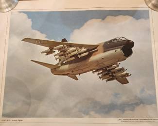 Poster of an A-7D Corsair II in flight, carrying multiple air-to-ground missiles under its wings. The A-7D variant was a U.S. Navy attack aircraft
