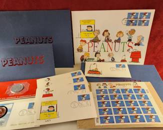 Hallmark Peanuts commemorative set, including a coin, first day cover, commemorative stamps, and matching envelopes