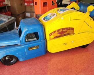  Vintage Structo City of Toyland No. 7 Utility Garbage Truck, featuring a bright blue cab and a yellow garbage body with the words "City of Toyland" printed on the side. Produced in the 1950s